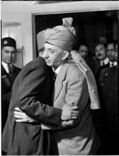 [Turbaned men embracing.]