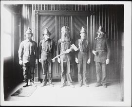 [Firemen in various firefighting gear.]