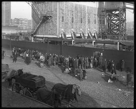East 110th Street at the Harlem River. Distributing coke [coal] to the poor people.
