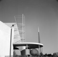 [Construction of the New York World's Fair site. Production and Distribution building, with the frames of the Trylon and Perisphere in the background.]