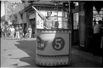 [Man selling tickets on Coney Island midway.]