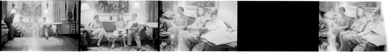[Unidentified family sitting on sofa.]