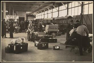 French Line, 610 Fifth Ave., "Normandie" Leaving Pier #88 N.R., Pier Scenes, Steward by Pile of Baggage.