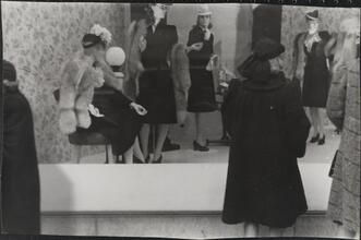 [Woman window shopping on 5th Avenue.]