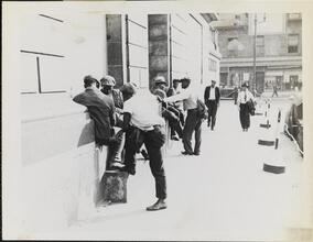 [Group of men hanging out on sidewalk.]
