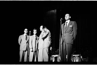 Vaughn Monroe [Monroe and a group of men singing on stage.]