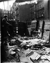 Boy on Fire Escape above a Littered Lot