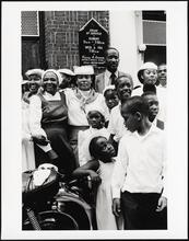 African-American congregation in front of church.
