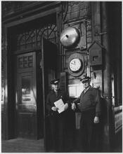 The Weehawken Ferry Story [Two employees in the Weehawken Ferry Terminal.]