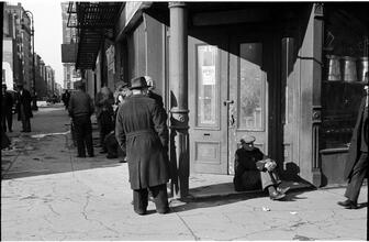 [Destitute men hanging out on sidewalk.]