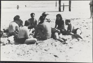 [Group of people relaxing on Coney Island beach.]