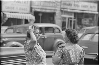 Street Conversations [Two women talking on the street.]