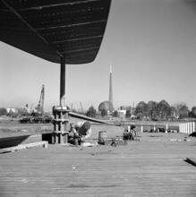 [Construction of the New York World's Fair site, with the frames of the Trylon and Perisphere in the background.]