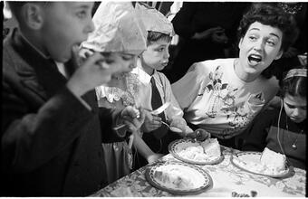 Deaf Children [Eating cake at a party.]