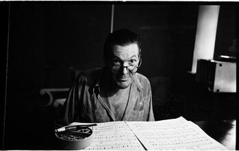 Peter Arno [Arno reading sheet music.]