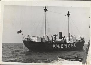 [Man rowing boat toward Ambrose vessel.]