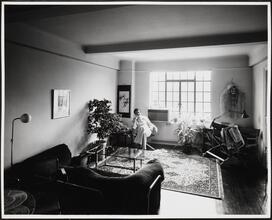 [Man sitting in a residential interior.]