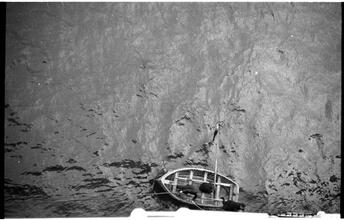 [Rowboat next to ship.]