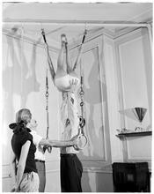 Fashion Models: Lisa Fonssagrives [Meg Mundy watching two men help a woman on gymnastics rings.]