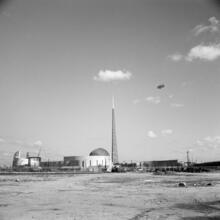 [Construction of the New York World's Fair site, with the steel frames of the Trylon and Perisphere visible.]