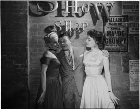 [Jack Carson with other performers at an autograph session.]