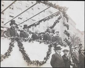 [Firemen in grandstands at an event.]