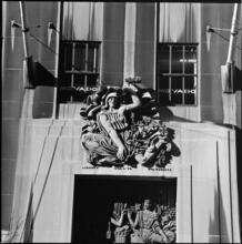 [Bronze panel and limestone cartouche above the main entrance to La Maison Française, 610 Fifth Avenue.]
