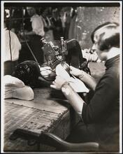 Interior, shoe factory with woman at machine