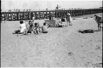 [People relaxing at Coney Island beach.]