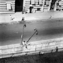 [Elevated view of a nearly empty city street.]