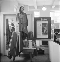 Bloomingdale's [Display in Bloomingdale's featuring a mannequin with a coat and "As Seen in LOOK Magazine" posters surrounding the display.]