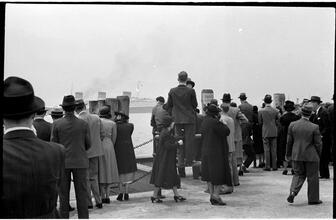 [People waiting on the dock of the Hoboken Ferry Terminal.]