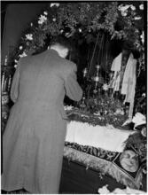 [Man at a decorated altar.]