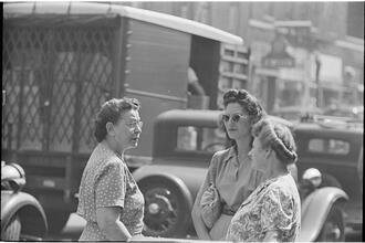Street Conversations [Three women talking on the street.]