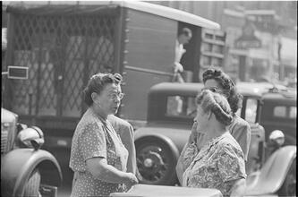 Street Conversations [Three women talking on the street.]