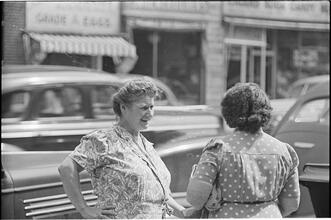 Street Conversations [Two women talking on the street.]