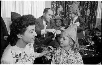 Deaf Children [Teacher putting a party hat on a child.]