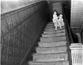 Children at the Top of Shabby Staircase