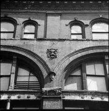 [Unidentified building with lion sculpture on façade.]