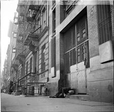 Man Lying on Sidewalk