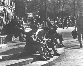 Untitled [Men sitting at base of flagstaff, Union Square]