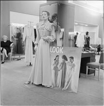 Lord & Taylor Display [A mannequin dressed in a housecoat in front of a LOOK magazine poster.]