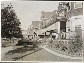 [Houses with awnings near Kingsbridge Armory.]