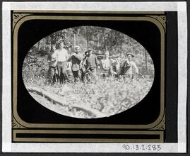 [Group of boys and farmer in the woods.]