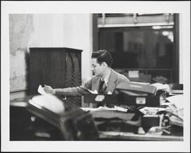 [Interior, office, man at desk.]