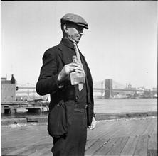 Waterfront. [Man a holding a bottle of denatured alcohol marked "Poison".]