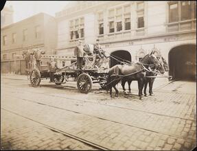 [Horse-drawn fire engine outside of station for Engine Company 31.]