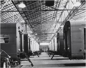 [Railroad cars in warehouse.]