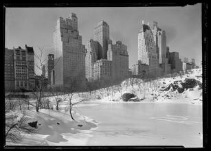 New York City views. 59th Street buidlings over frozen lake, horizontal.