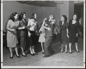 [Bobby Clark kissing a performer during a rehearsal for "Sweethearts".]